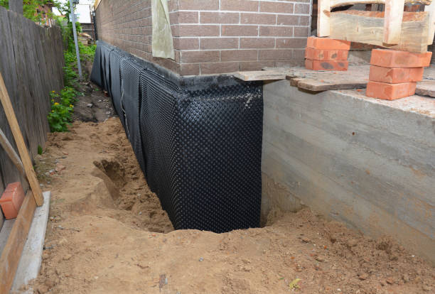 Happy homeowners after waterproofing job in Normandy